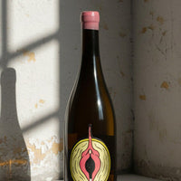 Bottle with a distinctive label on a textured wall background