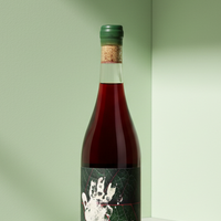Red wine bottle with a green label on a white background
